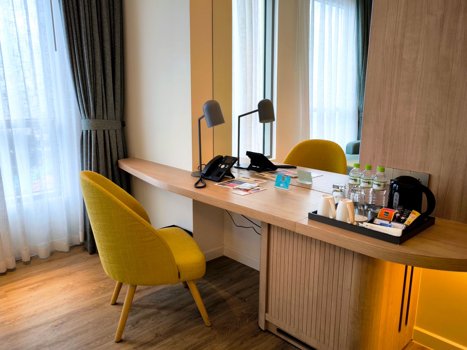 Eksempel på hotellrom med skrivebord og stol i tre i naturlig lys